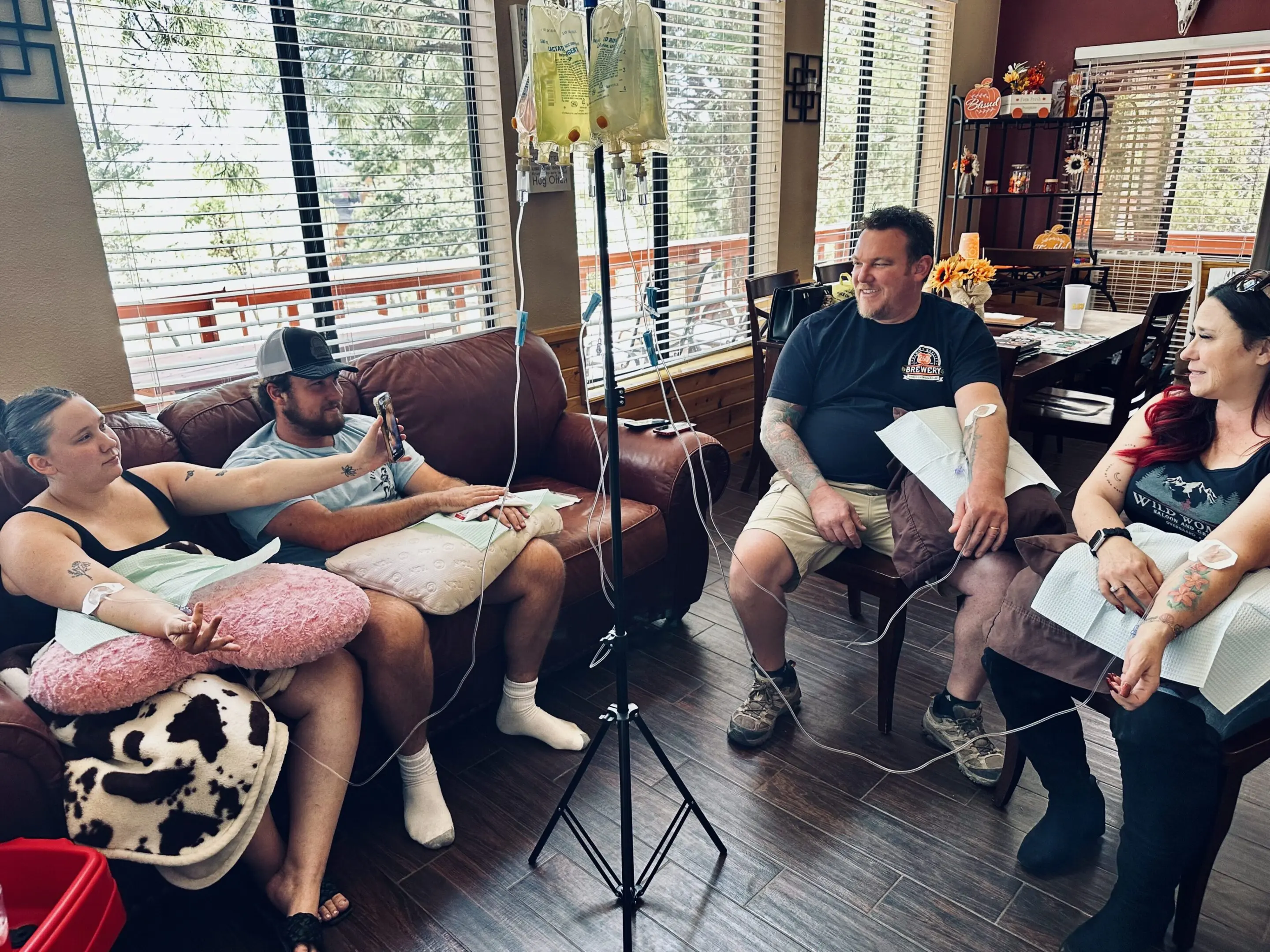 Three people sitting and chatting in a cozy cafe.